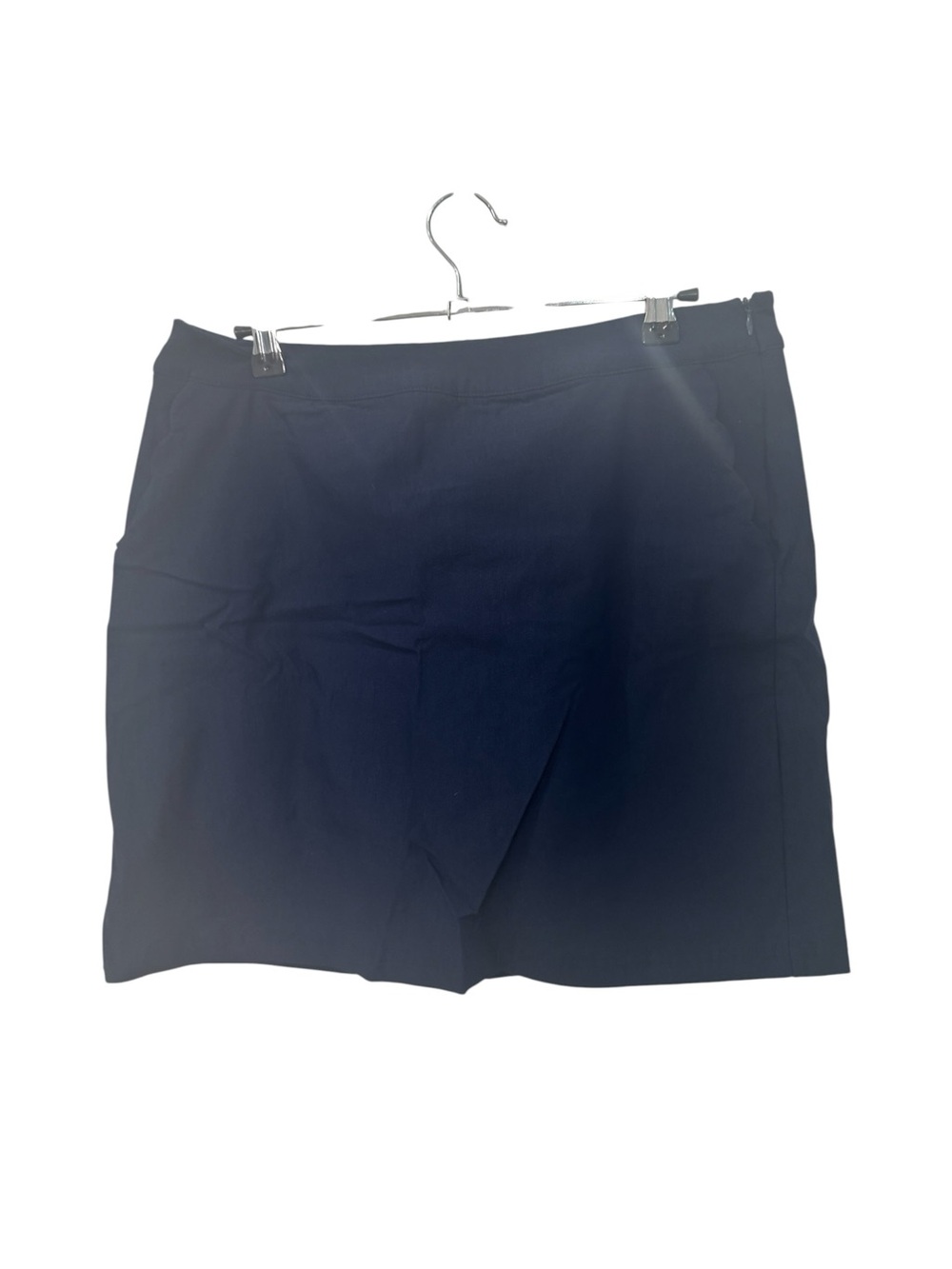 IZOD Golf performance skort is designed in a solid navy blue colorway women’s 10